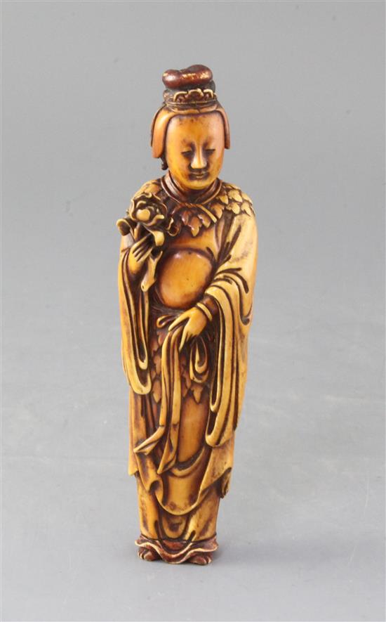 A Chinese Ming dynasty ivory figure of He Xiangu wearing a leaf cape, 17th century, 19.2cm, old restorations